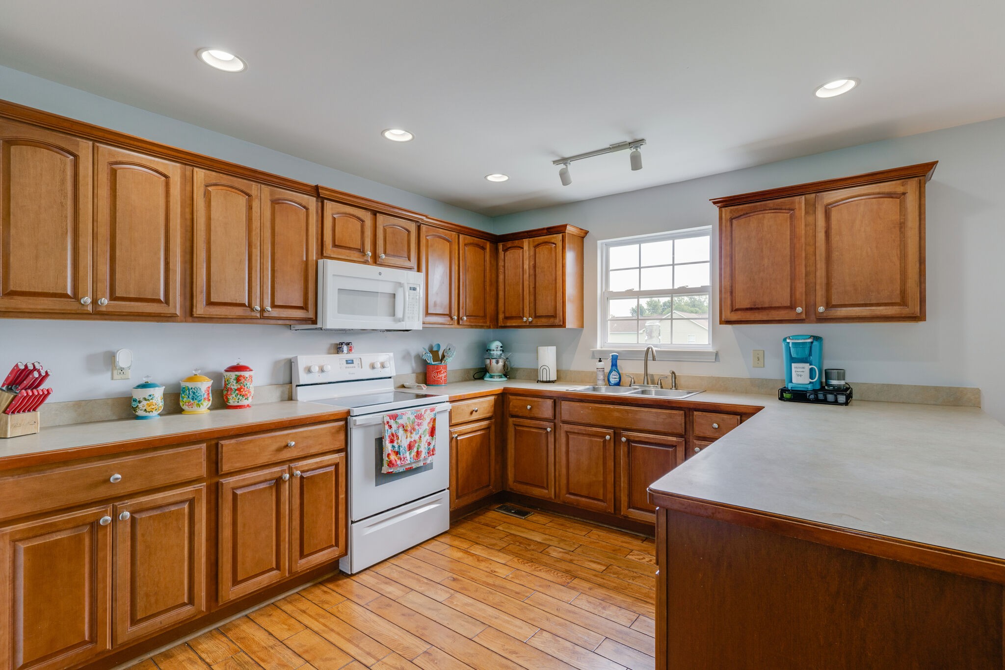 5259 East Robertson Road Cross Plains, TN 37049 - Photo 8 of 28 a kitchen with kitchen island granite countertop wooden cabinets stainless steel appliances a sink and a window