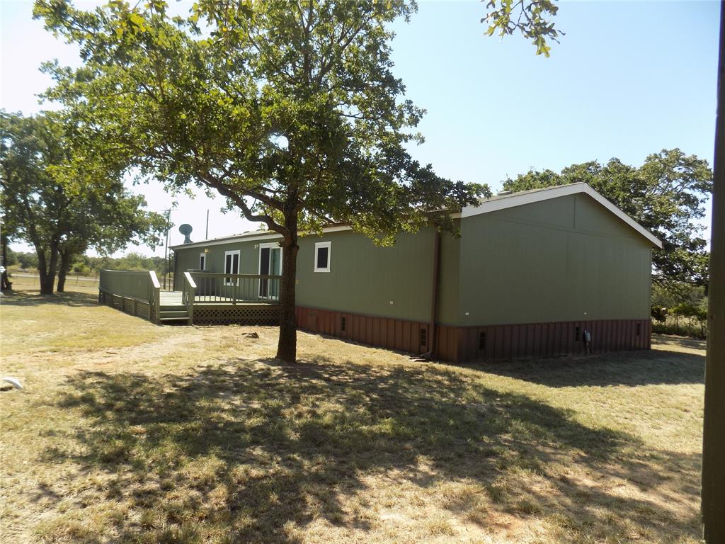 12792 Highway 199 Poolville, TX 76487 - Photo 7 of 24 Lovely view of the back door, deck and yard
