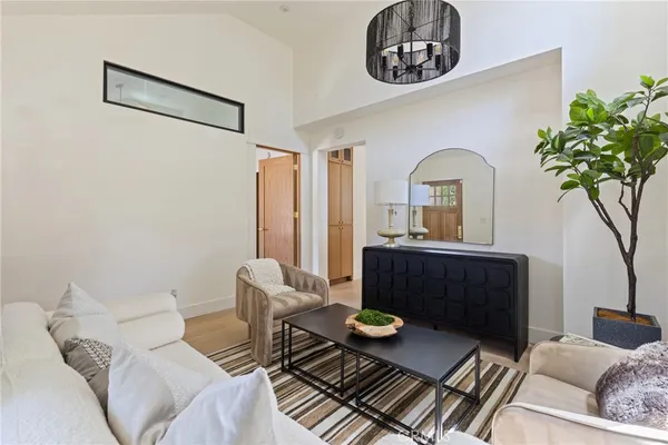 a living room with furniture and a potted plant