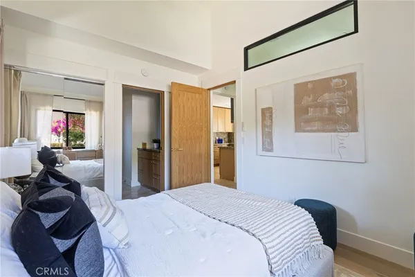 a bedroom with a bed and a mirror