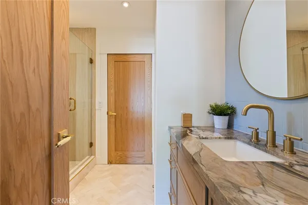 a bathroom with a granite countertop sink and a mirror