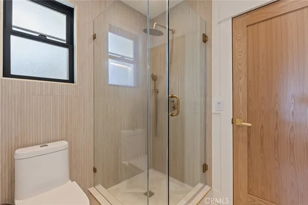 a bathroom with a shower and toilet