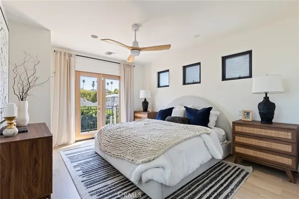 a bedroom with a large bed and a window