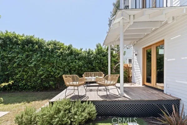 a view of a patio with couches table and chairs and potted plants