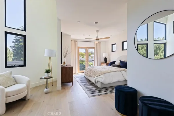 a bedroom with a bed couch and a window