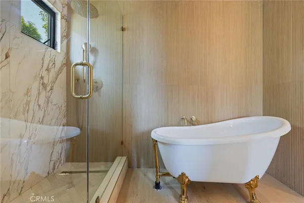 a white bath tub sitting next to a white toilet and sink