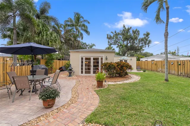 a view of a house with backyard sitting area and garden