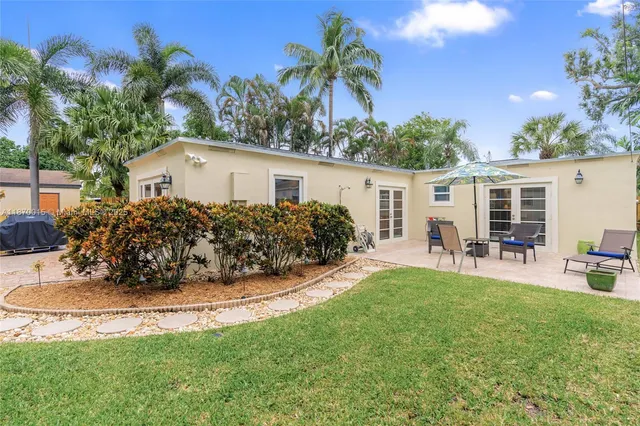 a view of a house with a yard and sitting area