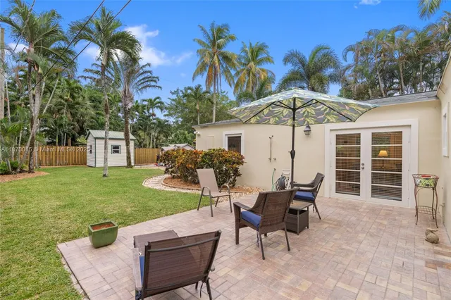 a view of a house with backyard sitting area and garden