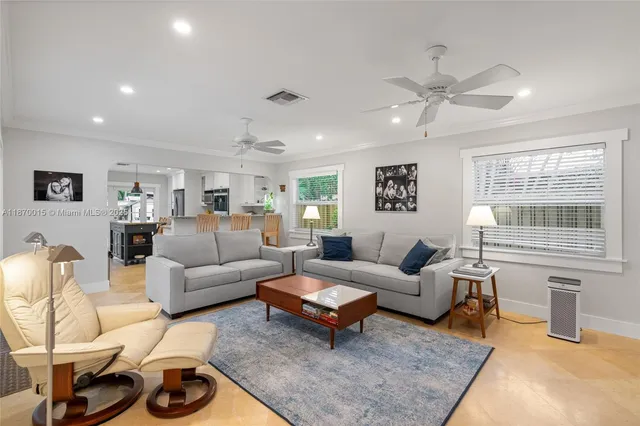 a living room with furniture a rug and a window