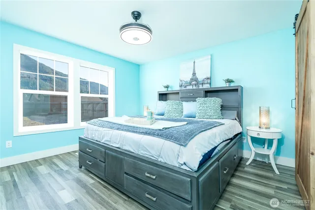 a bedroom with a bed and a window