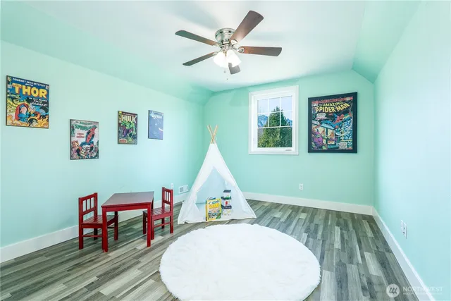 a view of a workspace with furniture and wooden floor
