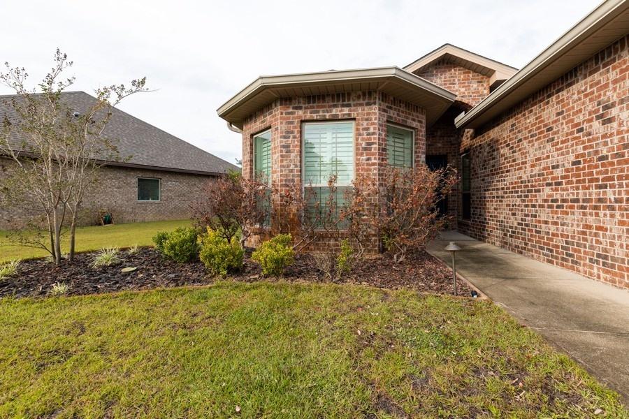 387 Pin Oak Loop Santa Rosa Beach, FL 32459 - Photo 2 of 36 a front view of a house with garden