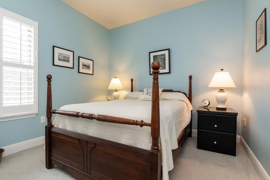 387 Pin Oak Loop Santa Rosa Beach, FL 32459 - Photo 12 of 36 a bedroom with a bed and a lamp