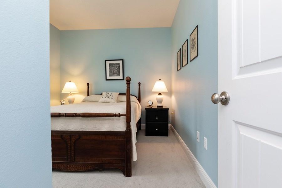 387 Pin Oak Loop Santa Rosa Beach, FL 32459 - Photo 13 of 36 a bedroom with a bed and a table