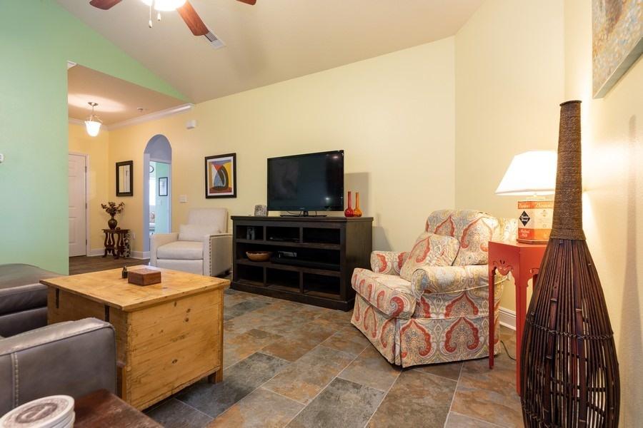 387 Pin Oak Loop Santa Rosa Beach, FL 32459 - Photo 16 of 36 a living room with furniture and a flat screen tv