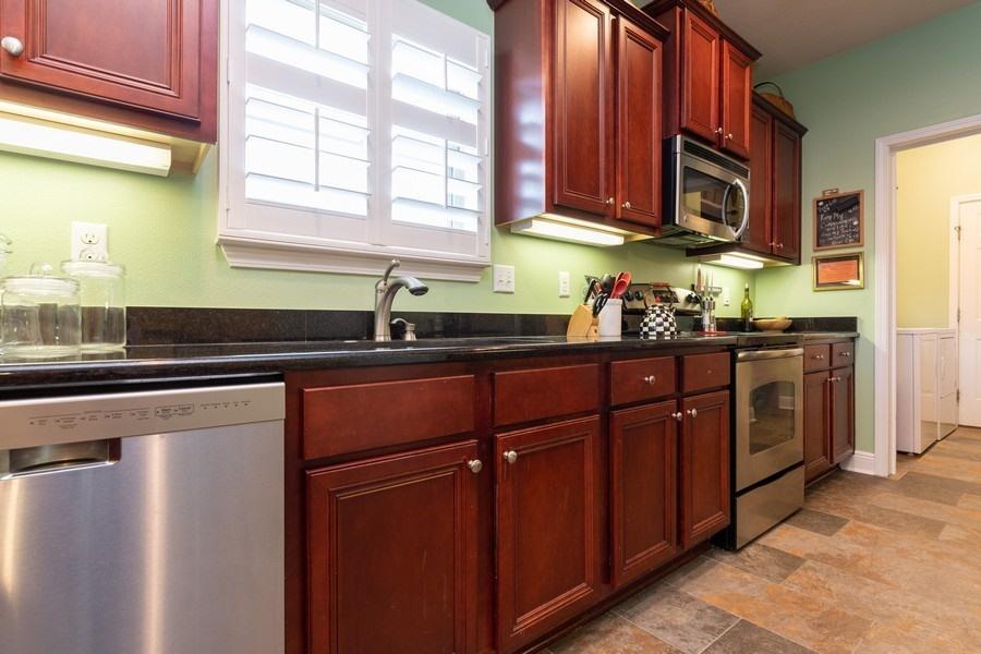387 Pin Oak Loop Santa Rosa Beach, FL 32459 - Photo 19 of 36 a kitchen with stainless steel appliances granite countertop a sink stove and cabinets