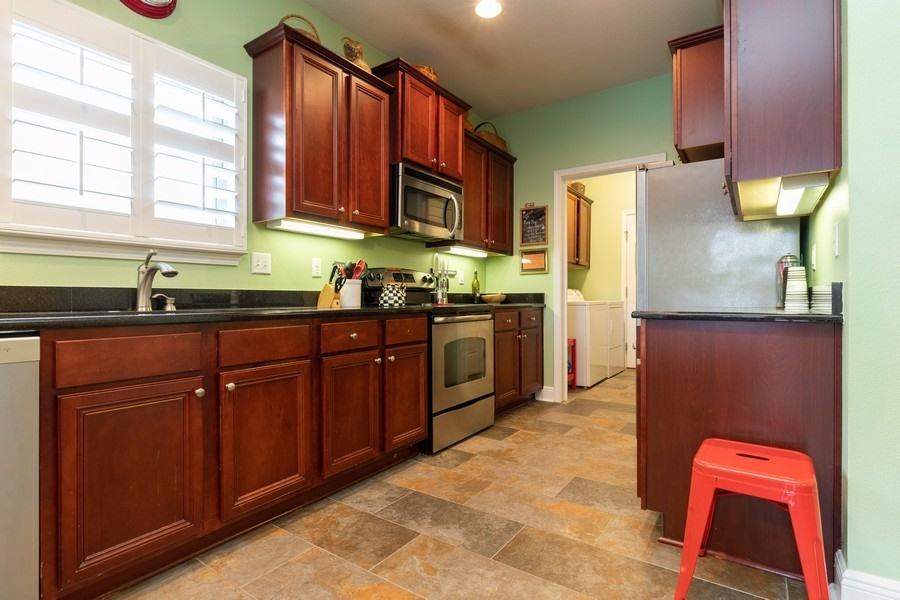 387 Pin Oak Loop Santa Rosa Beach, FL 32459 - Photo 20 of 36 a kitchen with stainless steel appliances granite countertop a sink stove and refrigerator
