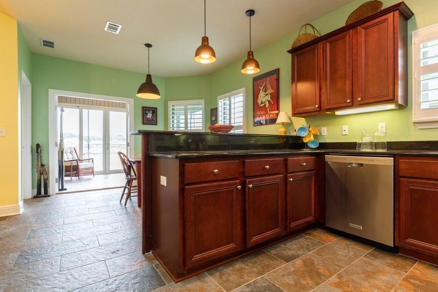 387 Pin Oak Loop Santa Rosa Beach, FL 32459 - Photo 21 of 36 a kitchen with stainless steel appliances granite countertop a sink and a cabinets