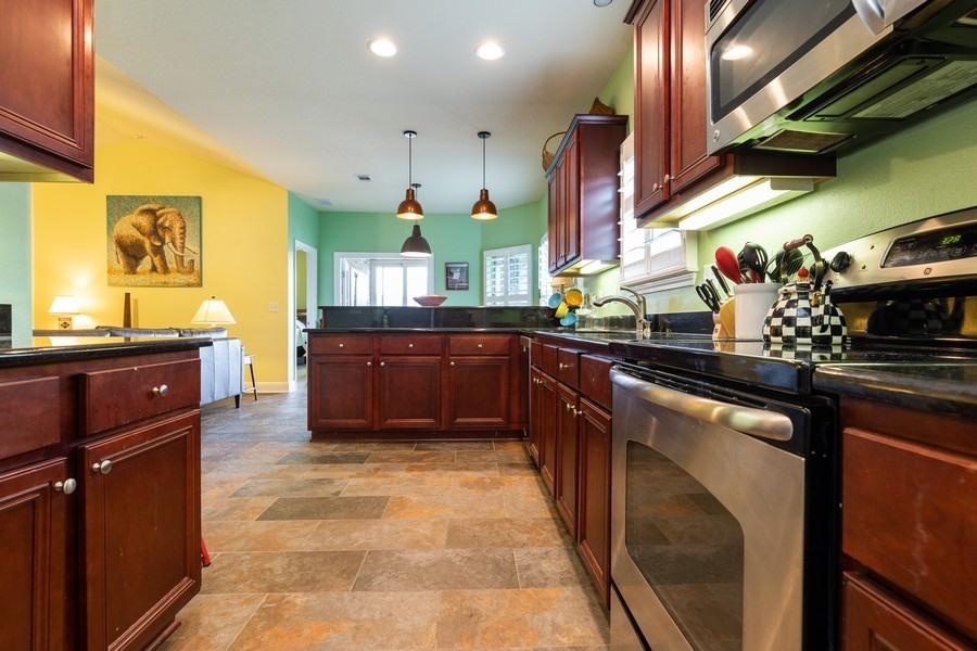 387 Pin Oak Loop Santa Rosa Beach, FL 32459 - Photo 22 of 36 a kitchen with stainless steel appliances granite countertop a sink stove and cabinets