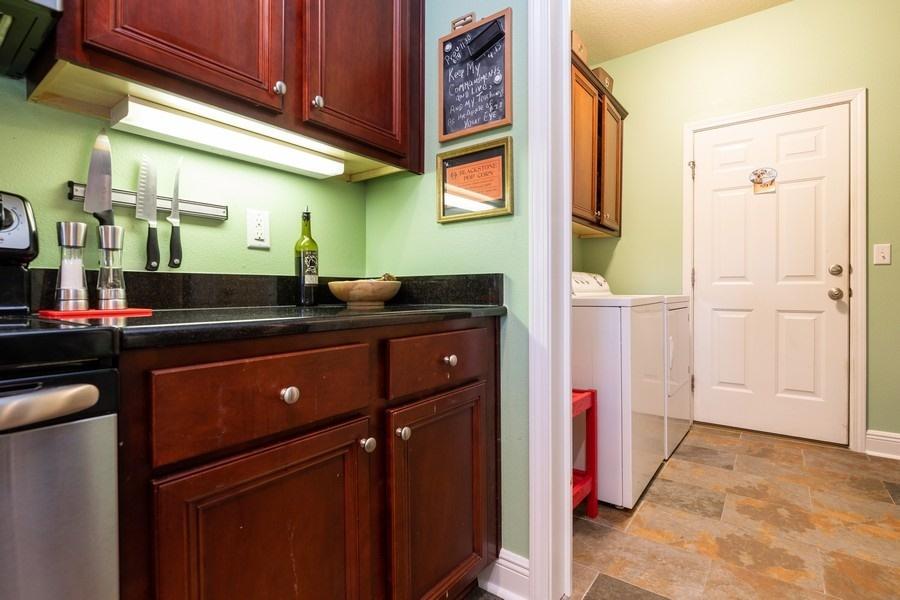 387 Pin Oak Loop Santa Rosa Beach, FL 32459 - Photo 23 of 36 a kitchen with a sink and cabinets