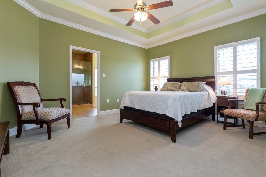 387 Pin Oak Loop Santa Rosa Beach, FL 32459 - Photo 25 of 36 a bedroom with a bed and a chandelier