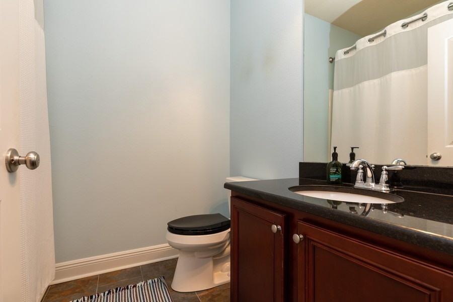 387 Pin Oak Loop Santa Rosa Beach, FL 32459 - Photo 10 of 36 a bathroom with a granite countertop sink a toilet and a mirror