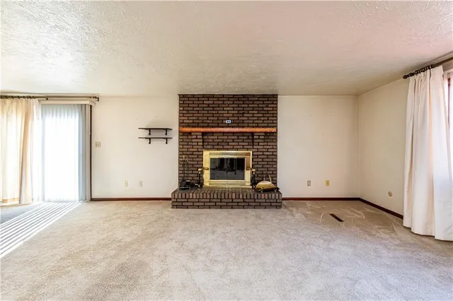 an empty room with fireplace