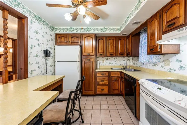 a kitchen with granite countertop a sink and a stove