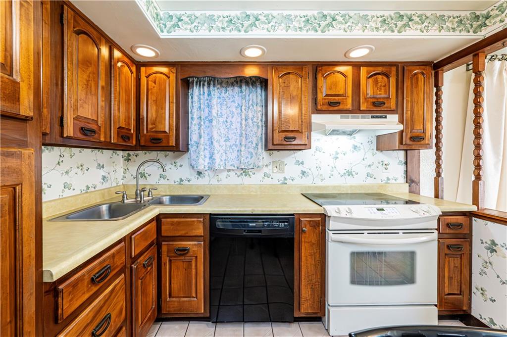 2002 Michael Avenue Irwin, PA 15642 - Photo 19 of 49 a kitchen with granite countertop a sink and a stove