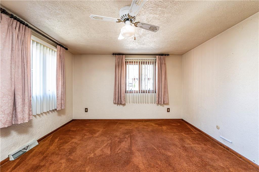 2002 Michael Avenue Irwin, PA 15642 - Photo 23 of 49 an empty room with chandelier fan and windows