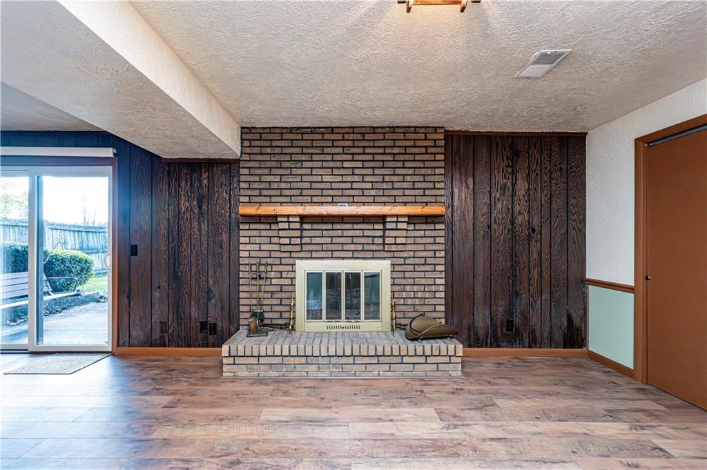 2002 Michael Avenue Irwin, PA 15642 - Photo 32 of 49 an empty room with wooden floor and a fireplace