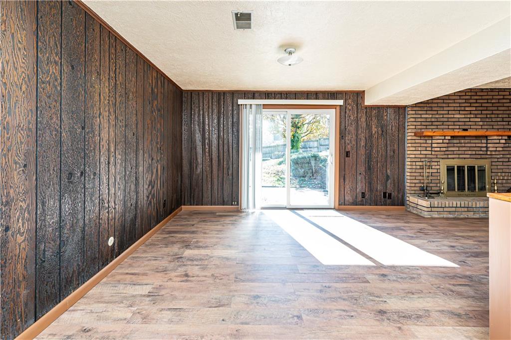 2002 Michael Avenue Irwin, PA 15642 - Photo 33 of 49 a view of an empty room with wooden floor and a fireplace