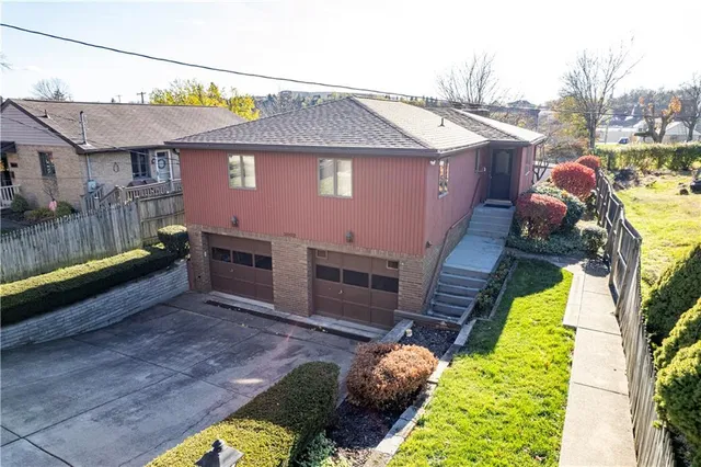 a aerial view of a house with a yard