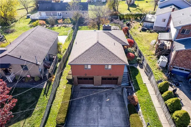 an aerial view of multiple houses with yard