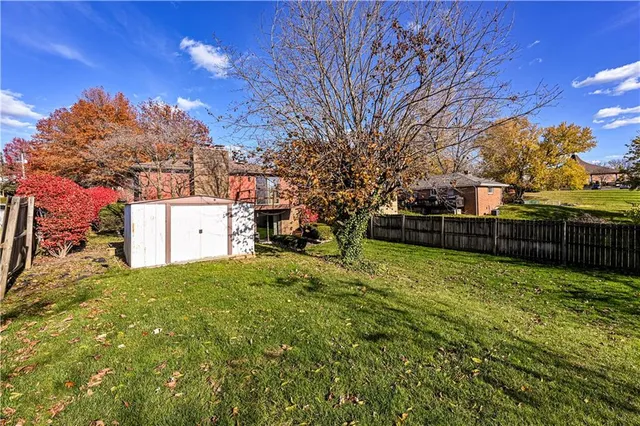 a view of a backyard with tree
