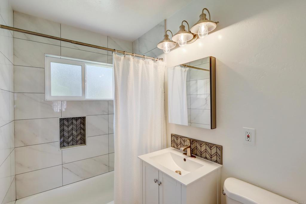 136 Hannalei Drive Vista, CA 92083 - Photo 14 of 32 a bathroom with a sink a toilet and mirror