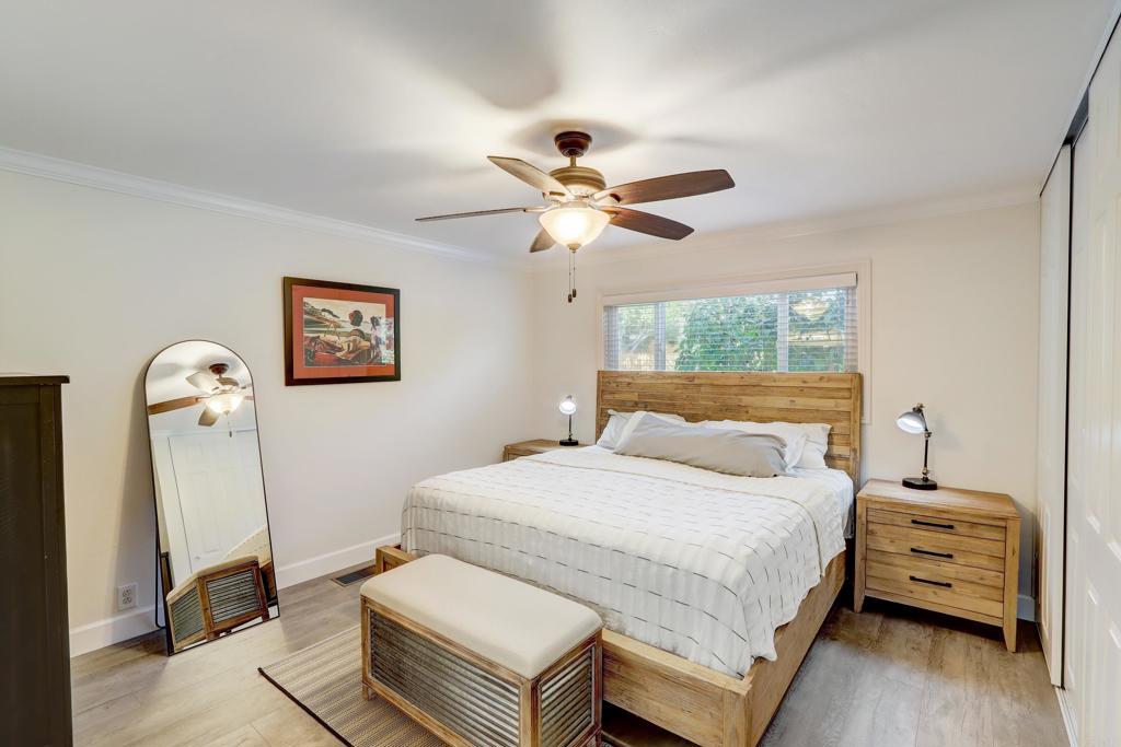 136 Hannalei Drive Vista, CA 92083 - Photo 15 of 32 a bedroom with a bed and a chandelier