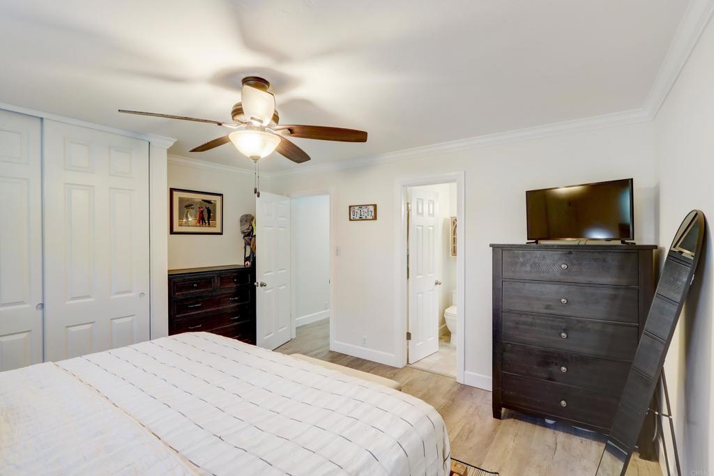 136 Hannalei Drive Vista, CA 92083 - Photo 18 of 32 a bedroom with a bed and a flat screen tv