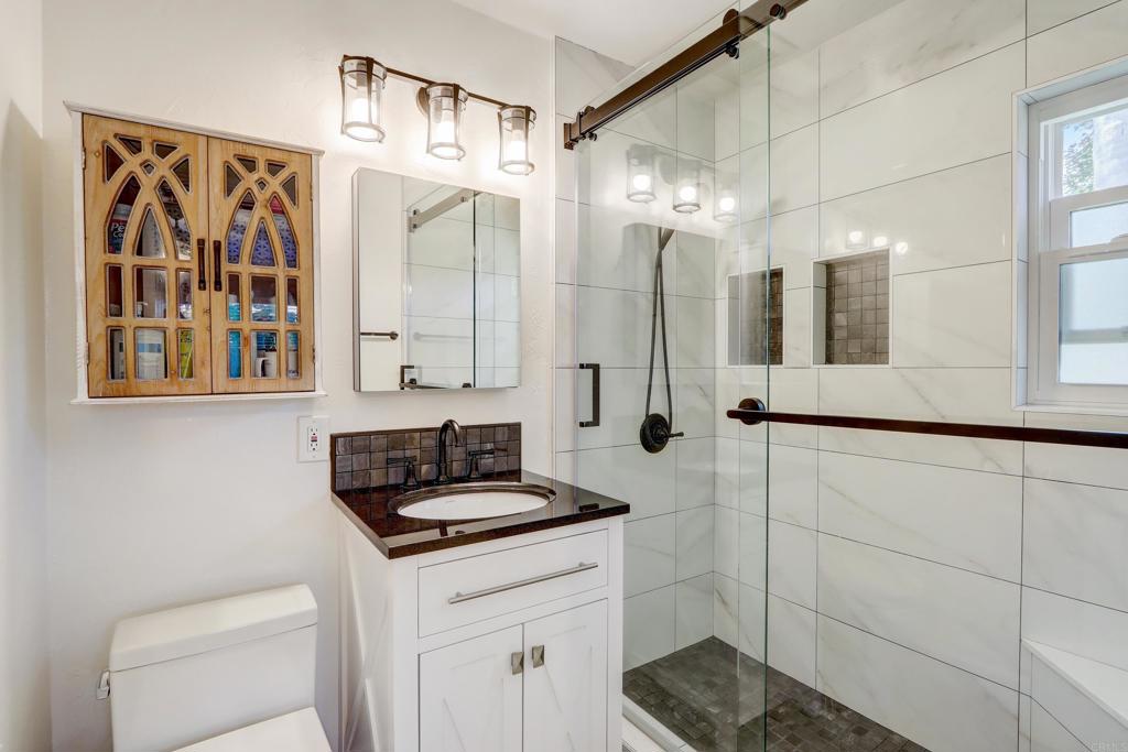 136 Hannalei Drive Vista, CA 92083 - Photo 19 of 32 a bathroom with a sink and a mirror