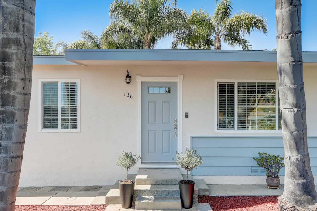 136 Hannalei Drive Vista, CA 92083 - Photo 2 of 32 a view of front door of house with potted plants