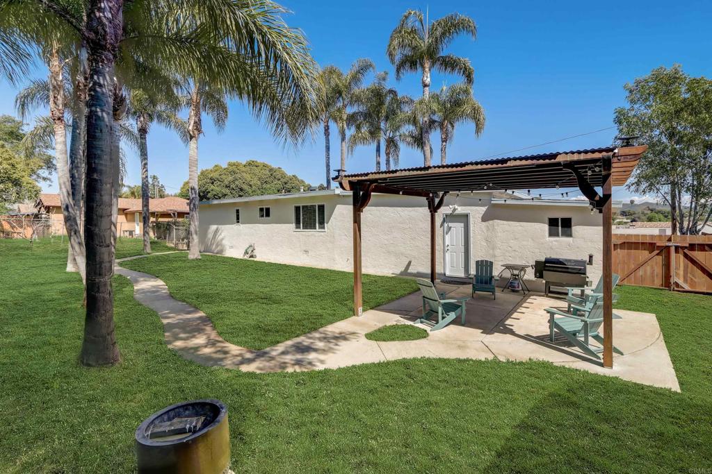 136 Hannalei Drive Vista, CA 92083 - Photo 26 of 32 a view of a white house with a big yard and potted plants