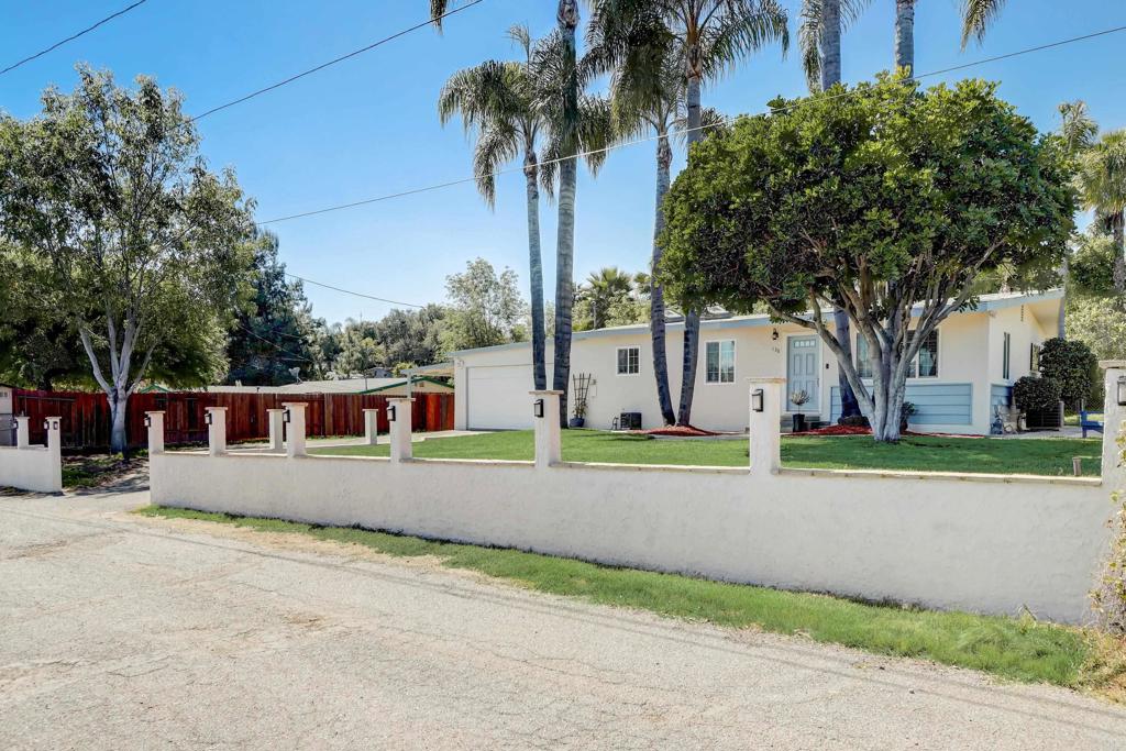 136 Hannalei Drive Vista, CA 92083 - Photo 29 of 32 front view of house with a yard and palm trees