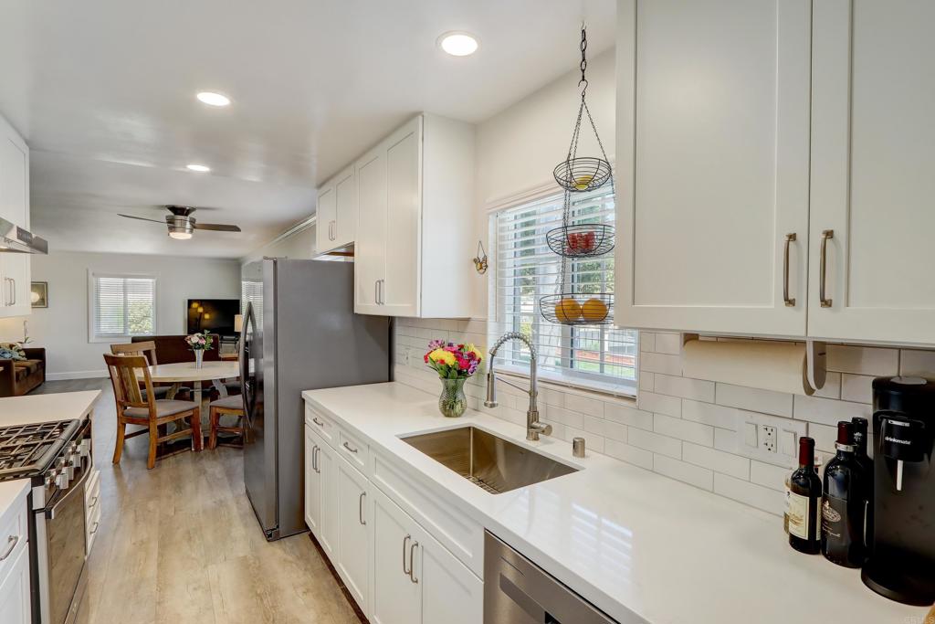 136 Hannalei Drive Vista, CA 92083 - Photo 8 of 32 a kitchen that has a lot of cabinets a sink and a stove in it