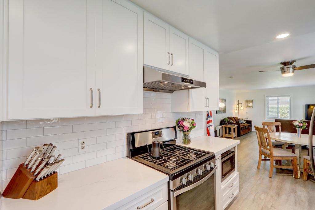 136 Hannalei Drive Vista, CA 92083 - Photo 9 of 32 a kitchen with a stove and wooden floor