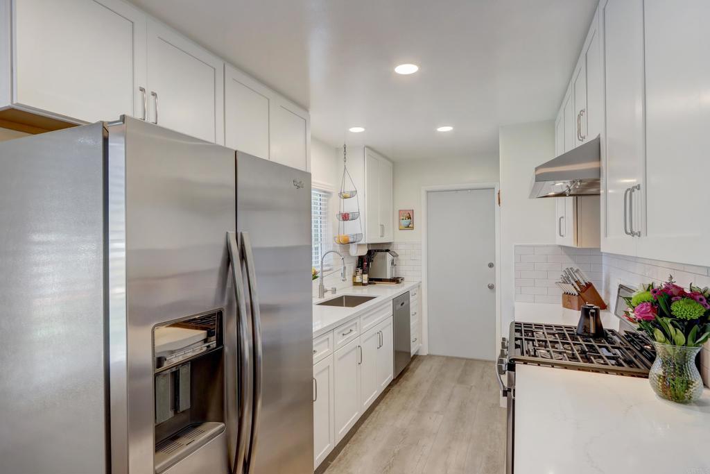 136 Hannalei Drive Vista, CA 92083 - Photo 10 of 32 a kitchen with stainless steel appliances granite countertop a refrigerator and a sink