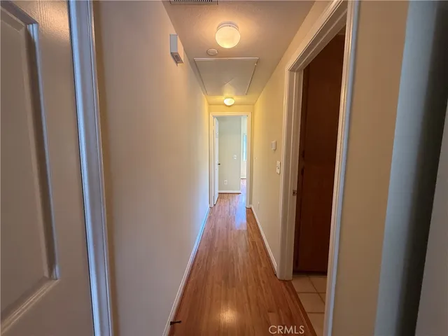 a view of a hallway with wooden floor