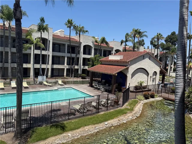 a front view of a house with garden and sitting area