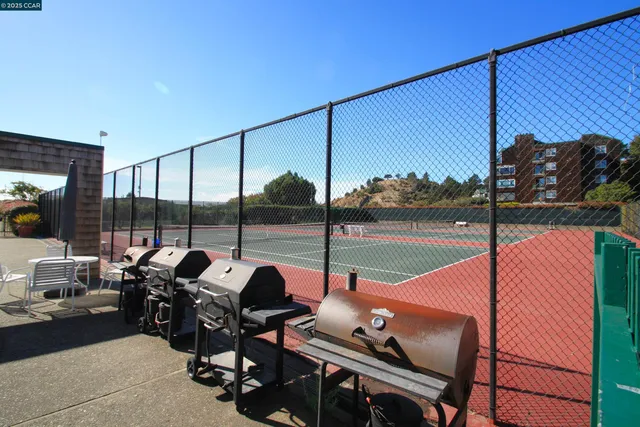 a dining room with furniture and a floor to ceiling window