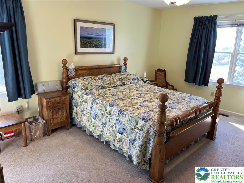 205 Spyglass Hill Road Bath, PA 18014 - Photo 20 of 51 a bed sitting in a bedroom next to a window